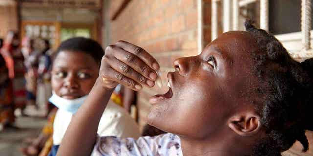 Eliza Tangwe, 18, takes a dose of the oral cholera vaccine in response to the latest cholera outbreak in Blantyre, Malawi, on Nov. 16, 2022. 