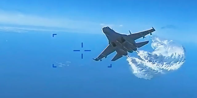 U.S. European Command on Thursday released video of a Russian Su-27 fighter jet colliding with a U.S. MQ-9 Reaper drone over the Black Sea, March 14. A screenshot shows a jet dumping fuel.