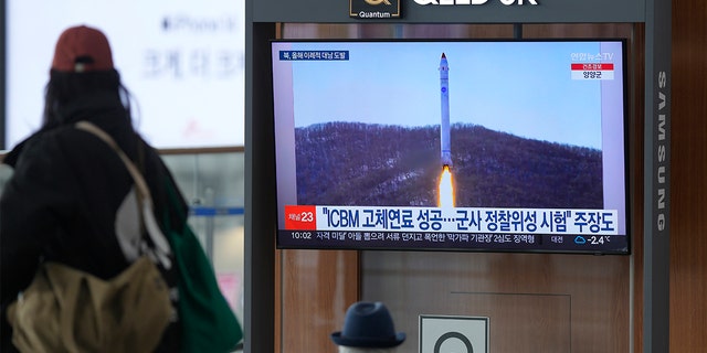 A TV screen shows a file image of North Korea's rocket with the test satellite during a news program at the Seoul Railway Station in Seoul, South Korea, Saturday, Dec. 31, 2022. The North fired another missile hours before South Korean and Japanese leaders were to meet Thursday. 