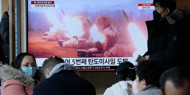 A TV screen shows a file image of North Korea's missiles launch during a news program at the Seoul Railway Station in Seoul, South Korea, Tuesday, March 14, 2023. 