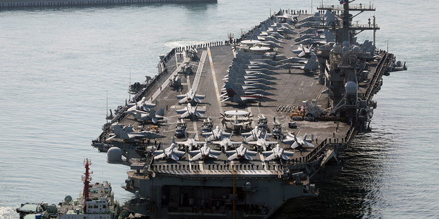 Aircraft carrier USS Nimitz approaches a naval base in Busan, South Korea, on Tuesday, March 28, 2023.
