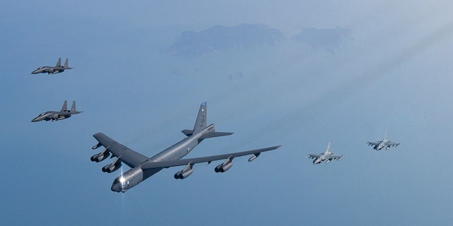 FILE PHOTO: In this photo provided by South Korea Defense Ministry, a U.S. Air Force B-52H Stratofortress aircraft, center, flies in formation with South Korea's Air Force KF-16 fighters and South Korea's Air Force F-15K fighters over the western sea of Korean peninsula during a joint air drill in South Korea, Monday, March 6, 2023.