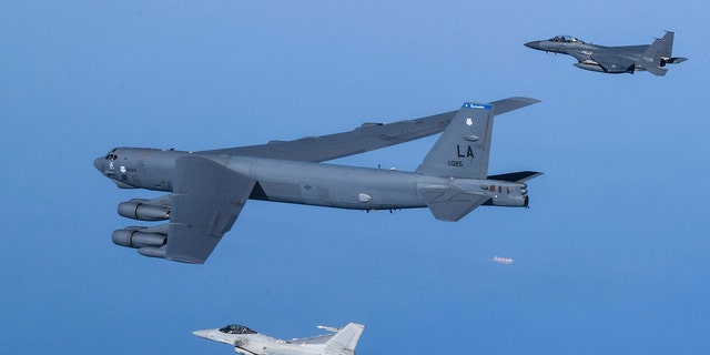 In this photo provided by South Korea Defense Ministry, a U.S. Air Force B-52H Stratofortress aircraft, center, flies in formation with South Korea's Air Force KF-16 fighters, bottom, and South Korea's Air Force F-15K fighters over the western sea of Korean peninsula during a joint air drill in South Korea, Monday, March 6, 2023. 