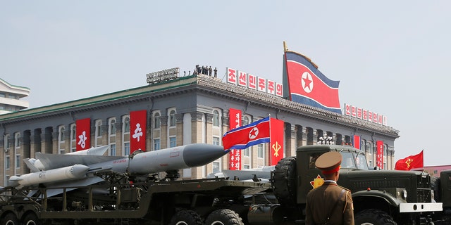 Missiles are driven past the stand with Kim Jong Un and other high-ranking officials during a military parade marking birthday of North Korea's deceased founding father, Kim Il Sung, in Pyongyang.