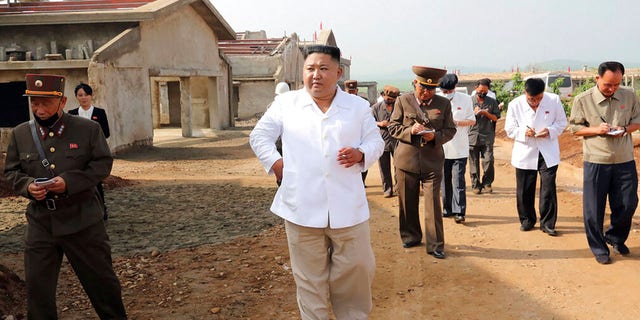 North Korean leader Kim Jong Un visits a chicken farm being built in Hwangju County, North Korea.