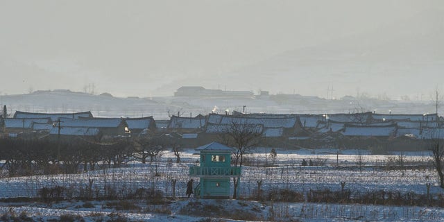 FILE: The portraits of late North Korean leaders Kim Il-Sung (L) and Kim Jong-Il (R) are seen in North Korea's Sakchu county in North Pyongan province, as seen from the Chinese border city of Dandong on January 10, 2018.