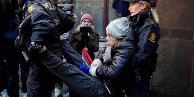 Swedish activist Greta Thunberg is carried away during a protest outside the Norwegian Ministry of Finance, in Oslo, on March 1, 2023. Norway's energy minister canceled his trip to the United Kingdom due to the protests.