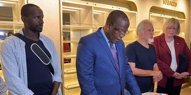 French journalist Olivier Dubois, left, who has been held hostage in the West Africa Sahel for nearly two years, and U.S. aid worker Jeffery Woodke who was held hostage for over six years listen to Niger's Interior Minister Hamadou Adamou Souley, center, after they were released in Niamey, Niger March 20, 2023.