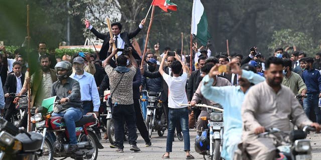 Supporters of former Pakistan Prime Minister Imran Khan block a road near Khan's residence to prevent officers from arresting him in Lahore, Pakistan, on March 15, 2023.