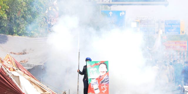 Pakistani security forces clash with supporters of former Prime Minister Imran Khan outside his residence to prevent his possible arrest in Lahore, Pakistan, on March 15, 2023.
