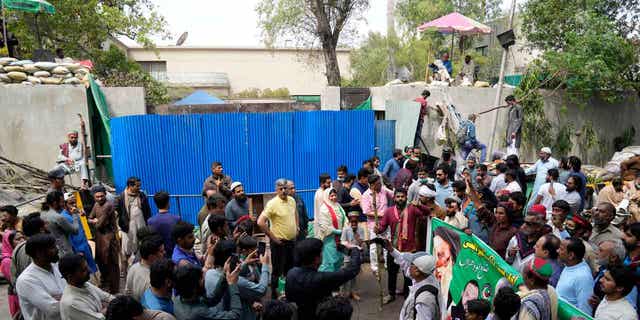 Supporters of former Prime Minister Imran Khan gather outside the Khan house in Lahore, Pakistan, on March 19, 2023.  Scores of Kahn supporters were arrested for attacking officers over the weekend.