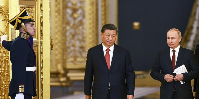 The announcement about the Abrams tanks heading to Ukraine comes as Chinese President Xi Jinping, center, and Russian President Vladimir Putin, right, are having a second day of meetings in Moscow.