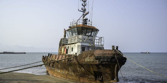 A stranded fishing boat on a sandy beach in the Gulf of Guinea off West Africa Feb. 6, 2022.