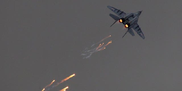 A Polish MiG-29 fires flares during a performance at the Radom Air Show on Aug. 24, 2013.