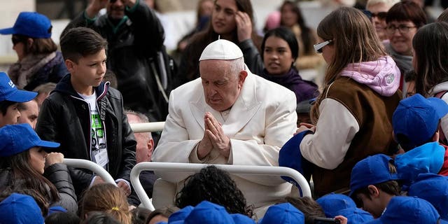 Pope Francis meets children at the end of his weekly general audience in St. Peter's Square, at the Vatican, Wednesday, March 29, 2023. Pope Francis went to a Rome hospital on Wednesday for some previously scheduled tests, slipping out of the Vatican after his general audience and before the busy start of Holy Week this Sunday. 