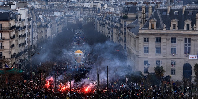 Protesters march, with the Pantheon monument in background, during a demonstration in Paris, on March 7, 2023.