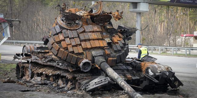 A damaged Russian tank is seen on a highway to Kyiv, Ukraine, in April 2022. A Russian lawmaker Wednesday says he wants to increase the punishment of those in Russia who are found guilty of "discrediting" the country's military.