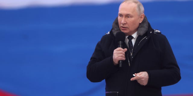 Russian President Vladimir Putin speaks during a concert in Luzhniki Stadium in Moscow.
