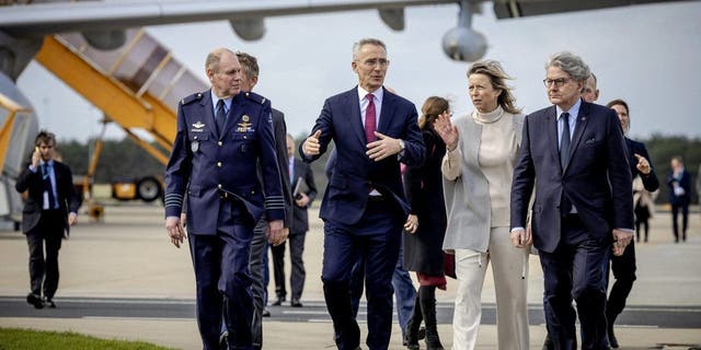 NATO Secretary-General Jens Stoltenberg, second left, Netherlands Defense Minister Kajsa Ollongren, second right, and European Commissioner for the Internal Market Thierry Breton, right, are seen at Eindhoven Air Base, Netherlands, on March 23, 2023.