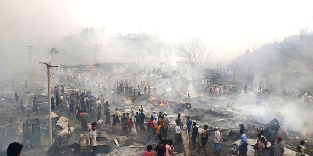 Rohingya refugees look for their belongings after a major fire broke in Balukhali camp in Bangladesh, on March 5, 2023. 