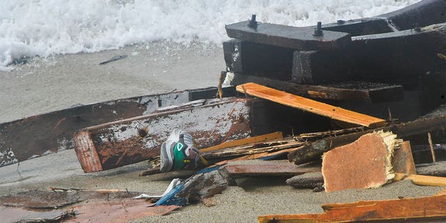 The wreckage from a capsized boat washes ashore at a beach near Cutro, Italy, Sunday, Feb. 26, 2023. Rescue officials say an undetermined number of migrants have died and dozens have been rescued after their boat broke apart off southern Italy.
