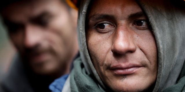 Miners wait for news of fellow workers after an explosion at a coal mine that according to authorities killed at least 11 people in Sutatausa, Cundinamarca department, Colombia, on March 15, 2023.