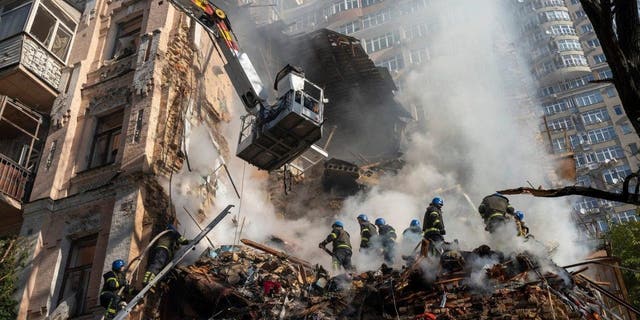 Firefighters work after a drone attack on buildings in Kyiv, Ukraine, Oct. 17, 2022. Iran has been supplying drones to Russia that have killed Ukrainian civilians and caused major damage to civilian infrastructure.