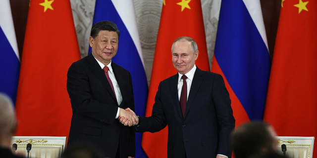 Russian President Vladimir Putin and Chinese President Xi Jinping shake hands in Moscow on Tuesday, March 21, 2023.