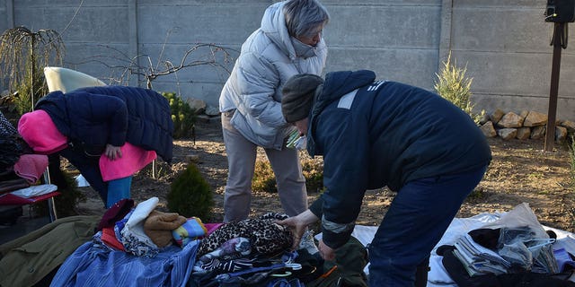 Ukrainians gather their belongings from a building that was destroyed from Russian bombs on March 31, 2023.