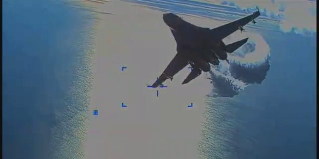 U.S. European Command on Thursday released video of a Russian Su-27 fighter jet colliding with a U.S. MQ-9 Reaper drone over the Black Sea, March 14. A screenshot shows a jet dumping fuel.