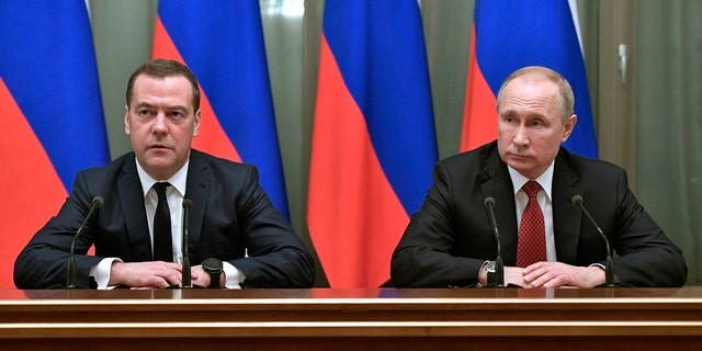Russian President Vladimir Putin, right, and then-Russian Prime Minister Dmitry Medvedev attend a cabinet meeting in Moscow in January 2020. Medvedev is warning Thursday that an arrest of Putin following an ICC warrant would amount to a "declaration of war."