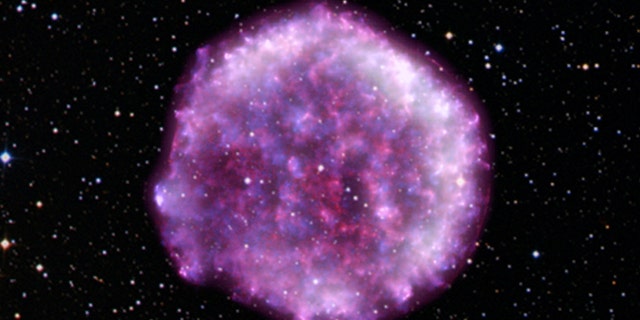 Using data from NASA’s Imaging X-ray Polarimetry Explorer (IXPE), international researchers have uncovered new information about the Tycho supernova remnant, an exploded star in the constellation Cassiopeia, the light from which was first seen on Earth in 1572. The results offer new clues about how shock waves created by these titanic stellar explosions accelerate particles to nearly the speed of light, and reveal, for the first time, the geometry of the magnetic fields close to the supernova’s blast wave, which forms a boundary around the ejected material, as seen in this composite image. IXPE data (dark purple and white) have been combined with data from NASA’s Chandra X-ray Observatory (red and blue) and overlaid with the stars in the field of view as captured by the Digitized Sky Survey.