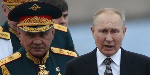 Russian President Vladimir Putin, right, and Defense Minister Sergei Shoigu, left, seen during the Navy Day Parade, on July 31, 2022, in Saint Petersburg, Russia. Putin has arrived to Saint Petersburg to review Main Naval Parade of over 50 military ships on Russia's Navy Day.