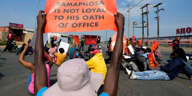 Economic Freedom Fighters members protest on the street in Tsakane township, South Africa, on March 20, 2023. South African police deployed in major cities on Monday ahead of planned anti-government protests by the leftist Economic Freedom Fighters party. 