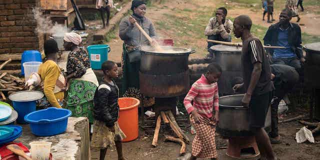 Community volunteers prepare meals for people who were displaced following tropical Cyclone Freddy in Blantyre, southern Malawi, on March 16, 2023. In Cyclone Freddy's aftermath, southern Africa has been warned of potential landslides and floods near Malawi and Mozambique.