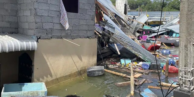 Household belongings float in water after an earthquake shook Machala, Ecuador, Saturday, March 18, 2023. 