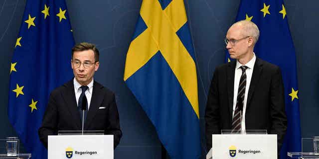 Sweden's Prime Minister Ulf Kristersson, left, and Oscar Stenstroem, ambassador in the cabinet preparation and chief negotiator in the NATO process, hold a press briefing on the NATO process in Stockholm.
