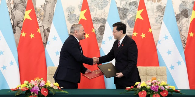 Chinese Foreign Minister Qin Gang shake hands with Honduras Foreign Minister Eduardo Enrique Reina during the ceremony of establishment of diplomatic relations between the two countries at Diaoyutai State Guesthouse March 26, 2023, in Beijing, China. 