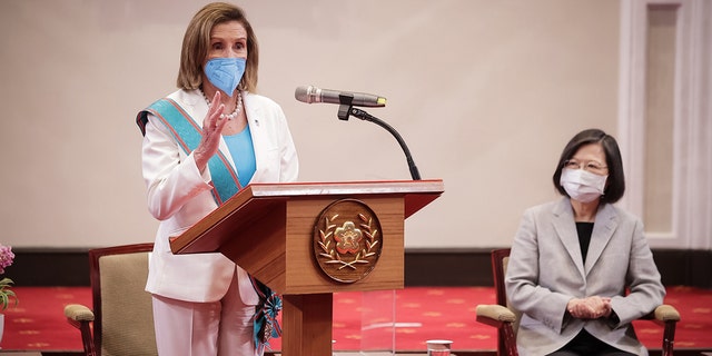 Then-House Speaker Nancy Pelosi speaks after receiving the Order of Propitious Clouds with Special Grand Cordon, Taiwan’s highest civilian honor, from Taiwan's President Tsai Ing-wen, right, at the president's office.