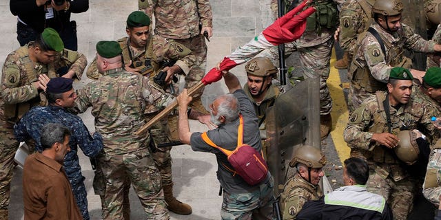 Retired army soldiers and other protesters demanding better pay clash with the Lebanese army in Beirut, Lebanon, on March 22, 2023. 