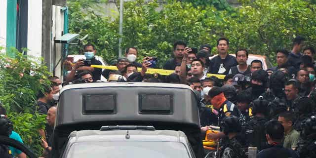 A senior police officer is carried on to an ambulance in Bangkok, Thailand, on March 15, 2023. Thai police detained the senior police officer who fired multiple gunshots from his home in Bangkok during a standoff.