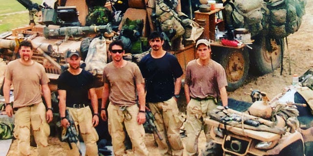 Delta Force team is pictured in front of a Pinzgauer on April 3, 2003, located somewhere east of the town of Rutba, Iraq, the day after the team lost an operator, Andy Fernandez, in battle. They decided to unsheathe their U.S. flags to show the enemy they were not discouraged one bit by their attack the day prior. Pictured from left to right, is Shawn Stevens, Craig Palmer, Mike Hefner, Brad Thomas, and Chris VanSant.