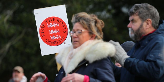 A protester holds a sign saying "Stop the Boats" as protesters listen to speeches on Feb. 25, 2023 in Skegness, England. 