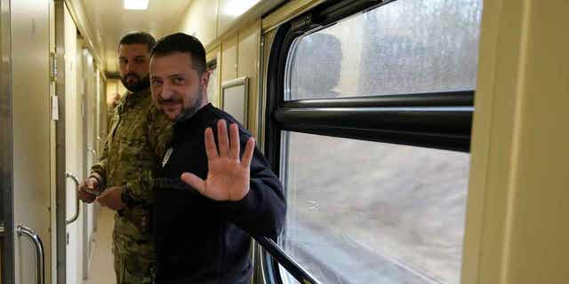 Ukrainian President Volodymyr Zelenskyy waves goodbye after an interview on a train traveling to Kyiv, Ukraine, on March 28, 2023. In the interview Zelenskyy claims he invited Chinese leader Xi Jinping to visit Ukraine.