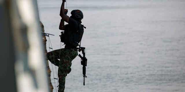 A Ghanaian soldier performs hook and climb drills at Tema port, Ghana, on March 9, 2023. Around 1,300 military personnel from 29 countries in Africa are training in Ghana and Ivory Coast, amid surging jihadi violence.