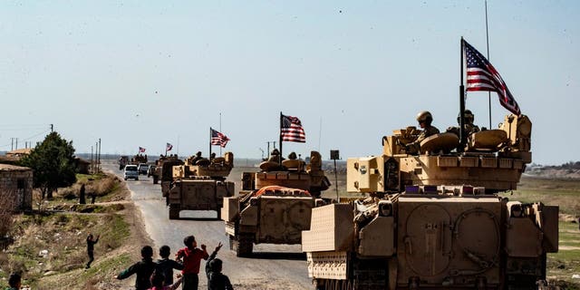 U.S. Bradley Fighting Vehicles (BFV) patrol in the Suwaydiyah oil fields in Syria's northeastern Hasakah province on February 13, 2021. 
