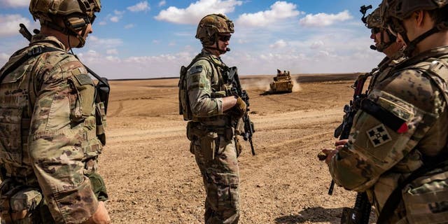 Troops from the Syrian Democratic Forces (SDF) Special Operations and the U.S.-led anti-jihadist coalition take part in heavy-weaponry military exercises in the countryside of Deir Ezzor in northeastern Syria, on March 25, 2022. 