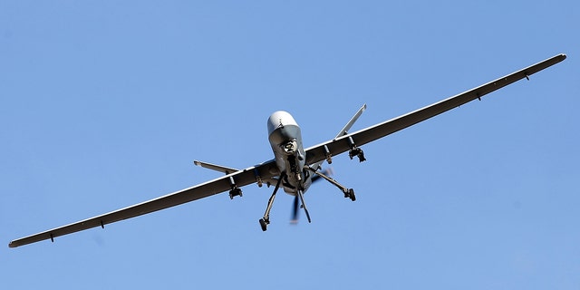 An MQ-9 Reaper remotely piloted aircraft flies by during a training mission at Creech Air Force Base on Nov. 17, 2015, in Indian Springs, Nevada.