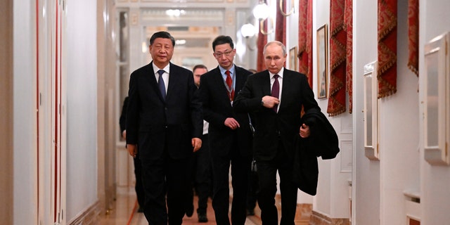 Chinese President Xi Jinping, left, and Russian President Vladimir Putin walk after their talks at the Kremlin in Moscow March 20, 2023. 