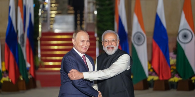 Indian Prime Minister Narendra Modi, right, and Russian President Vladimir Putin pose for photographs as Putin arrives at Hyderabad House in New Delhi, India, on Monday, Dec. 6, 2021.